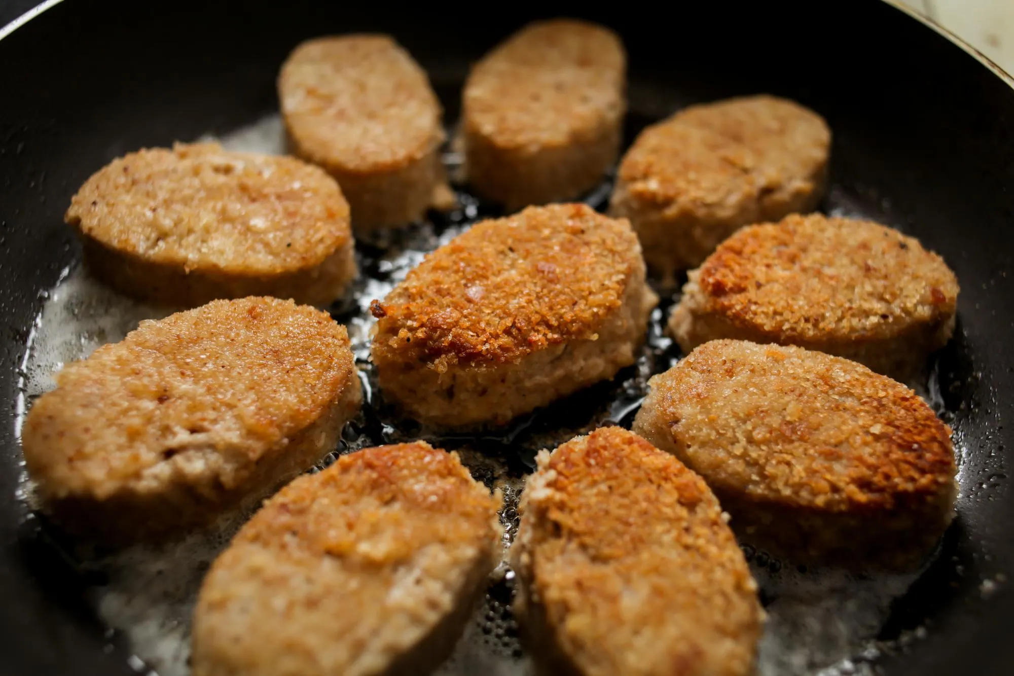 chicken cutlets fried in sunflower oil in a frying pan