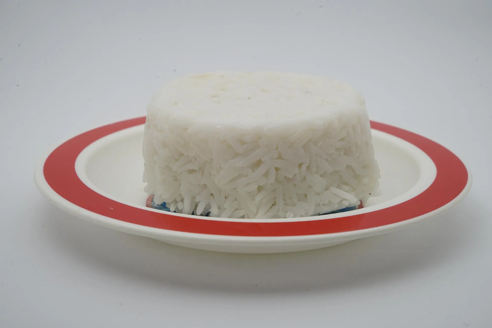 Close-up of ice cream in bowl over white background