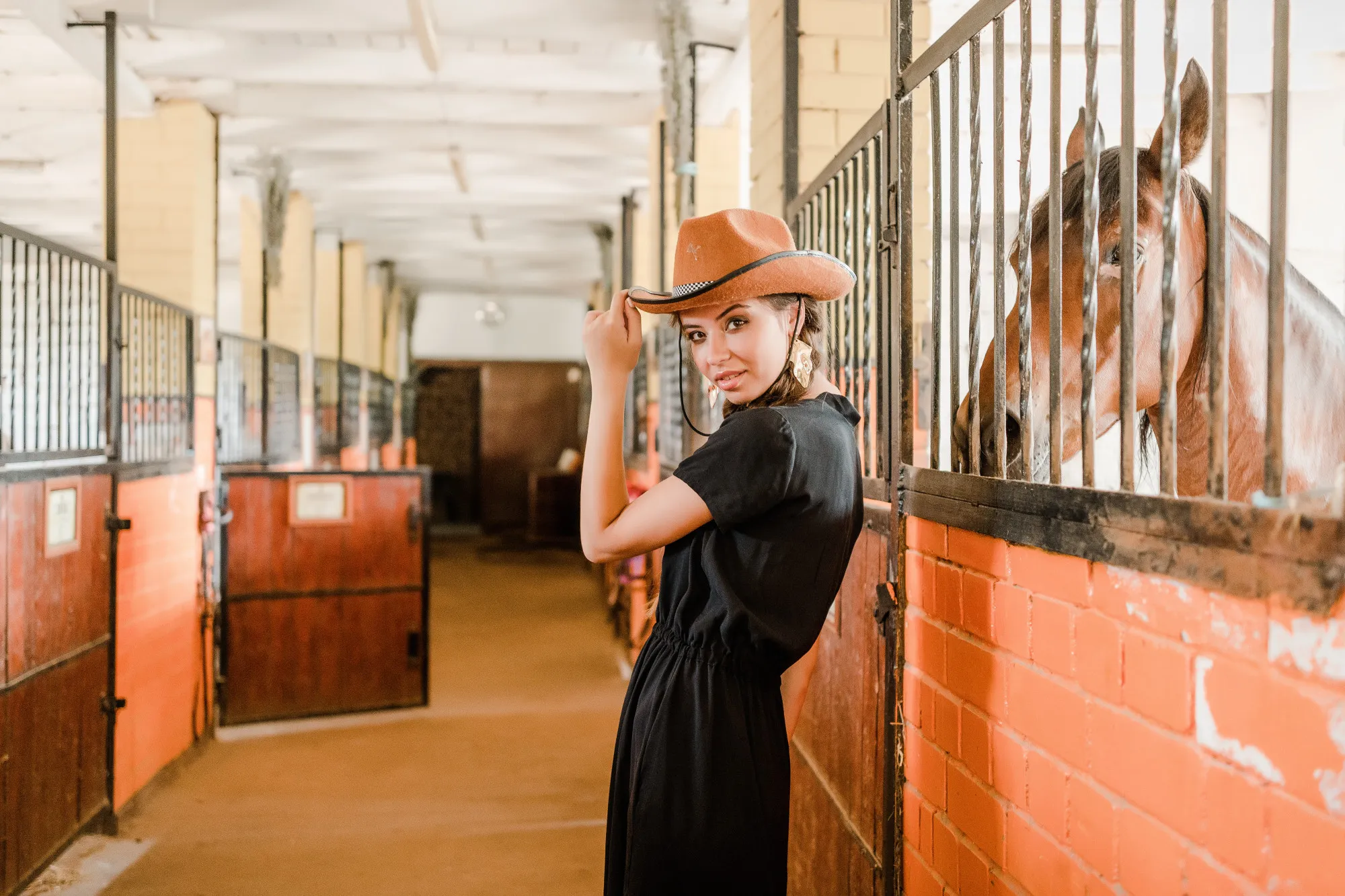 Cowgirl in a horse staple on a ranch