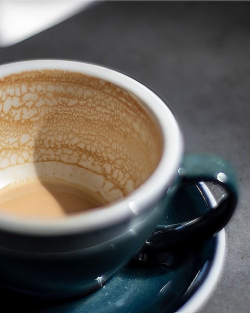 empty coffee cup patterns on coffee ceramic on concrete table and green ceramic cup
