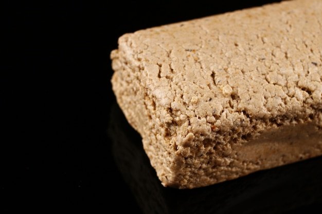 Halvah piece on black surface and place for copy space