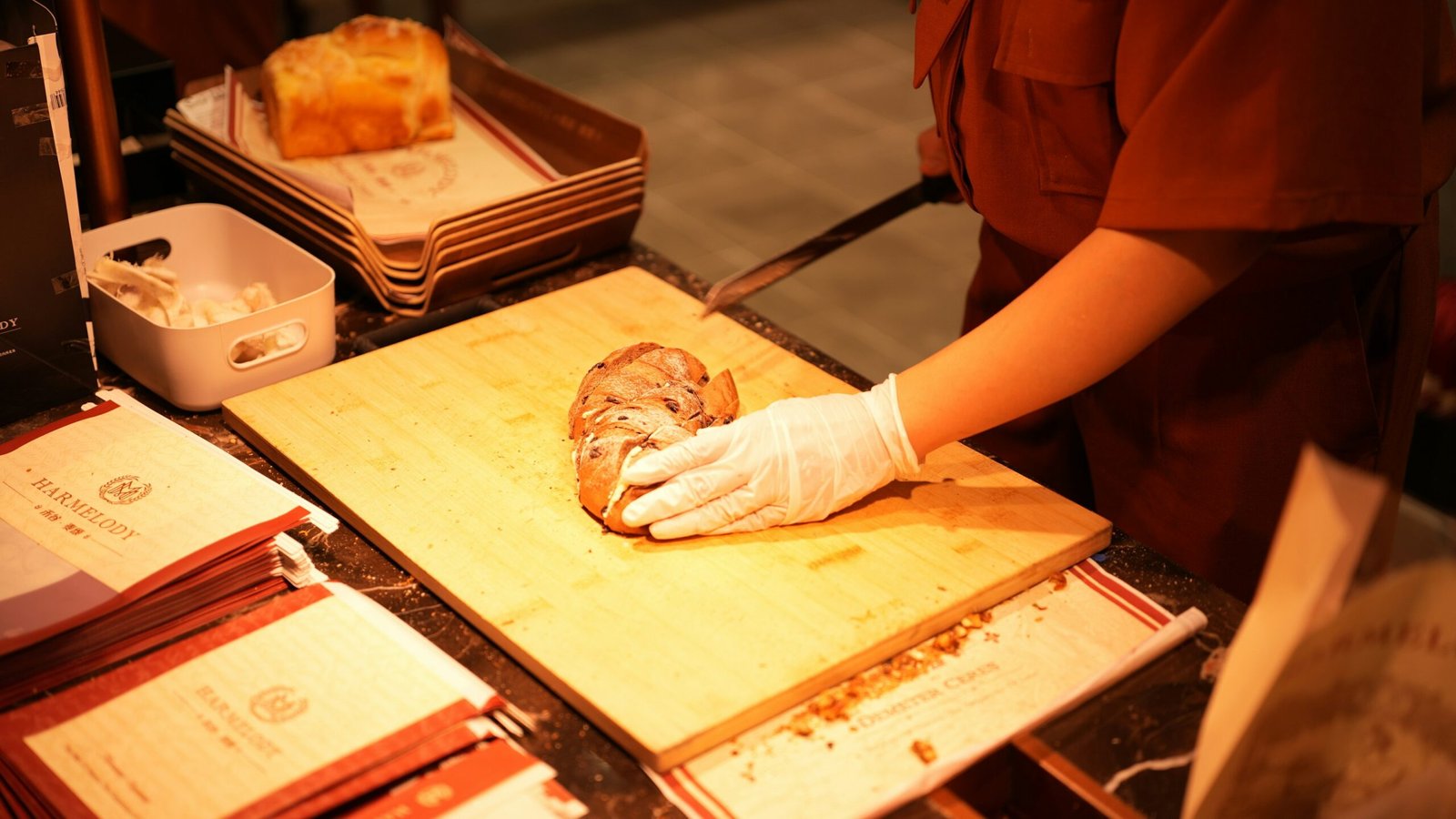 A chef prepares food on a wooden cutting board.