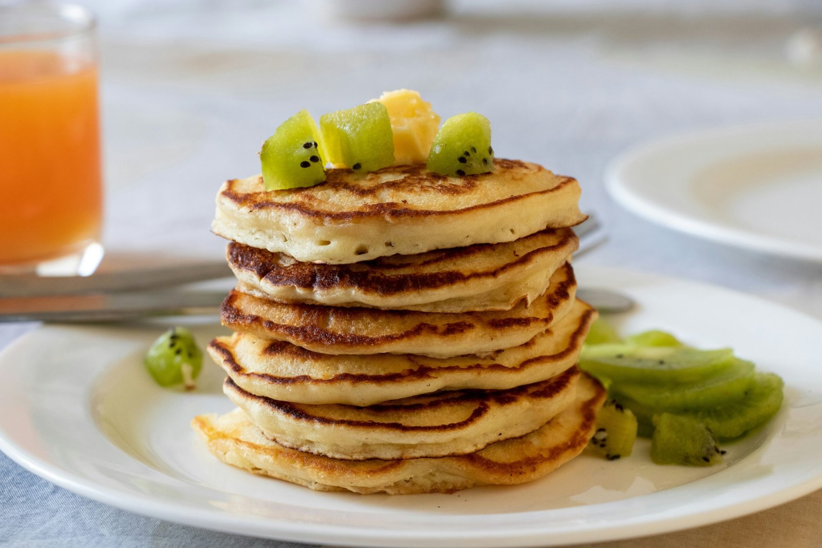 brown pancakes with sliced lemon on white ceramic plate