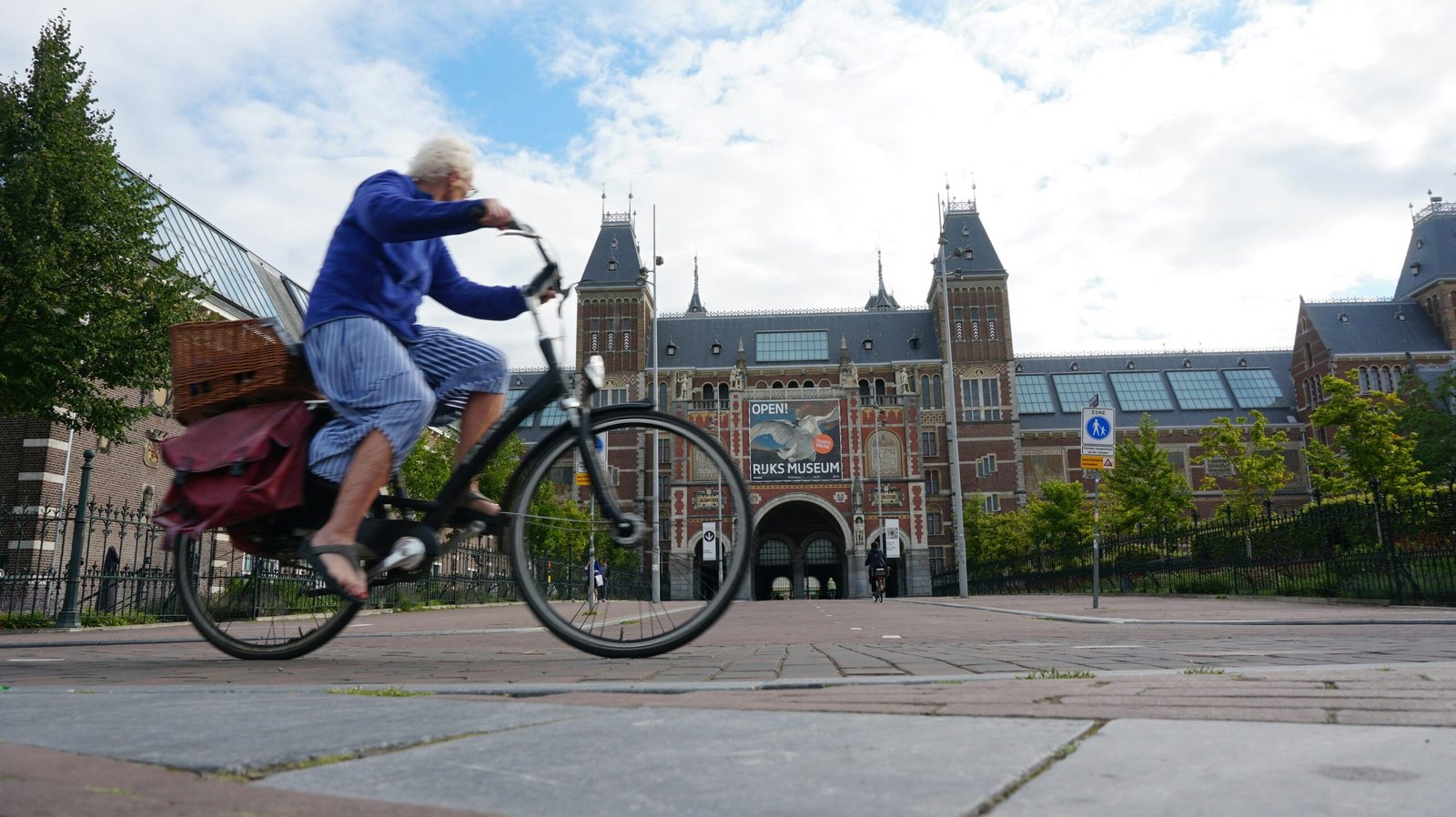woman in blue long sleeve shirt riding on black bicycle during daytime