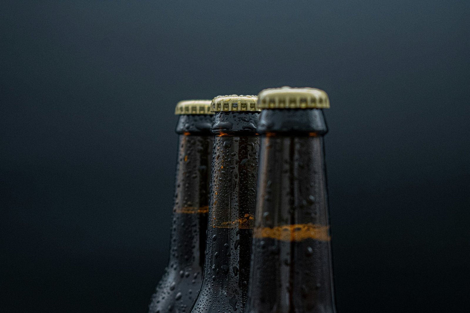 a close up of three bottles of beer