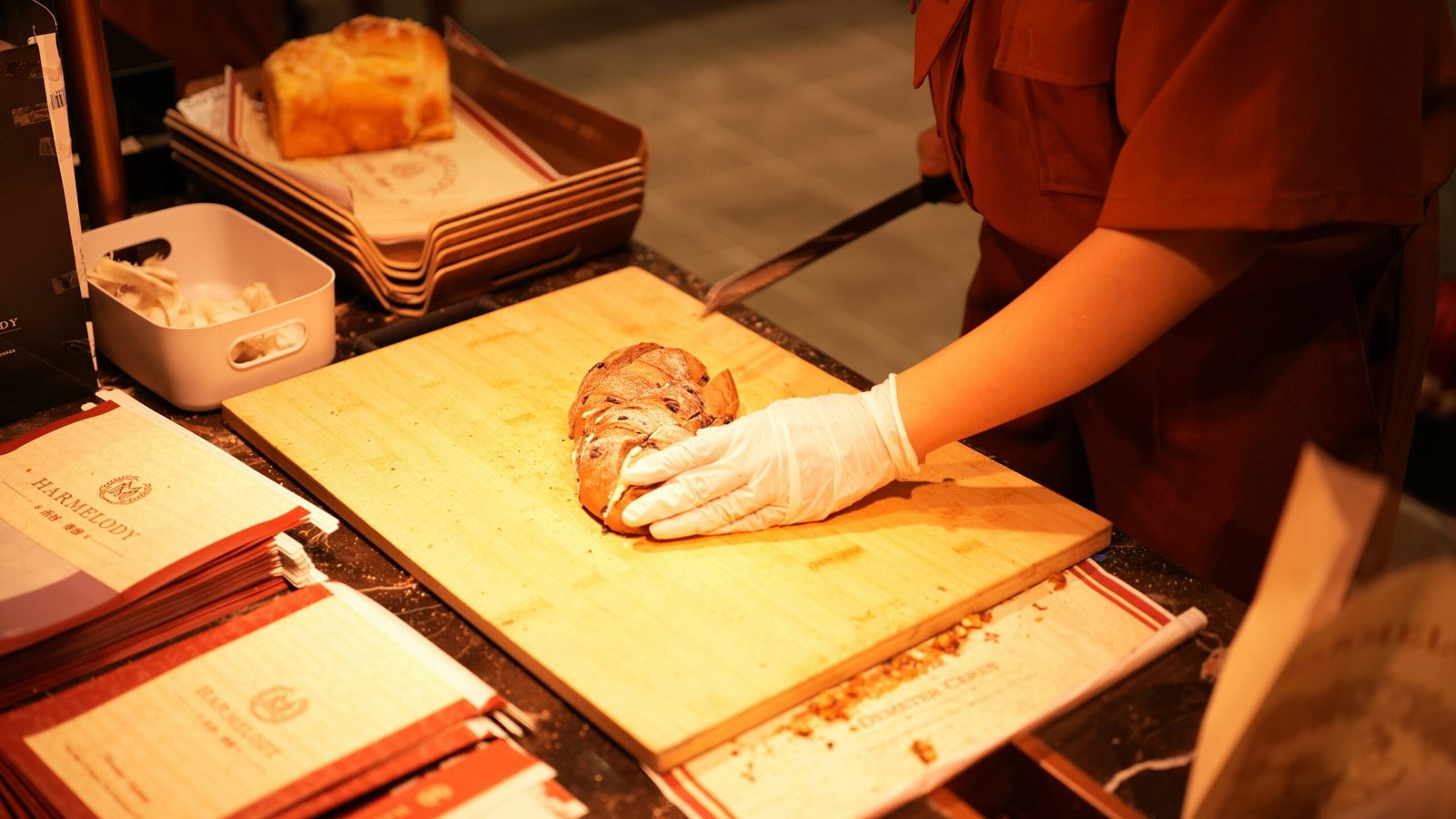 A chef prepares food on a wooden cutting board.