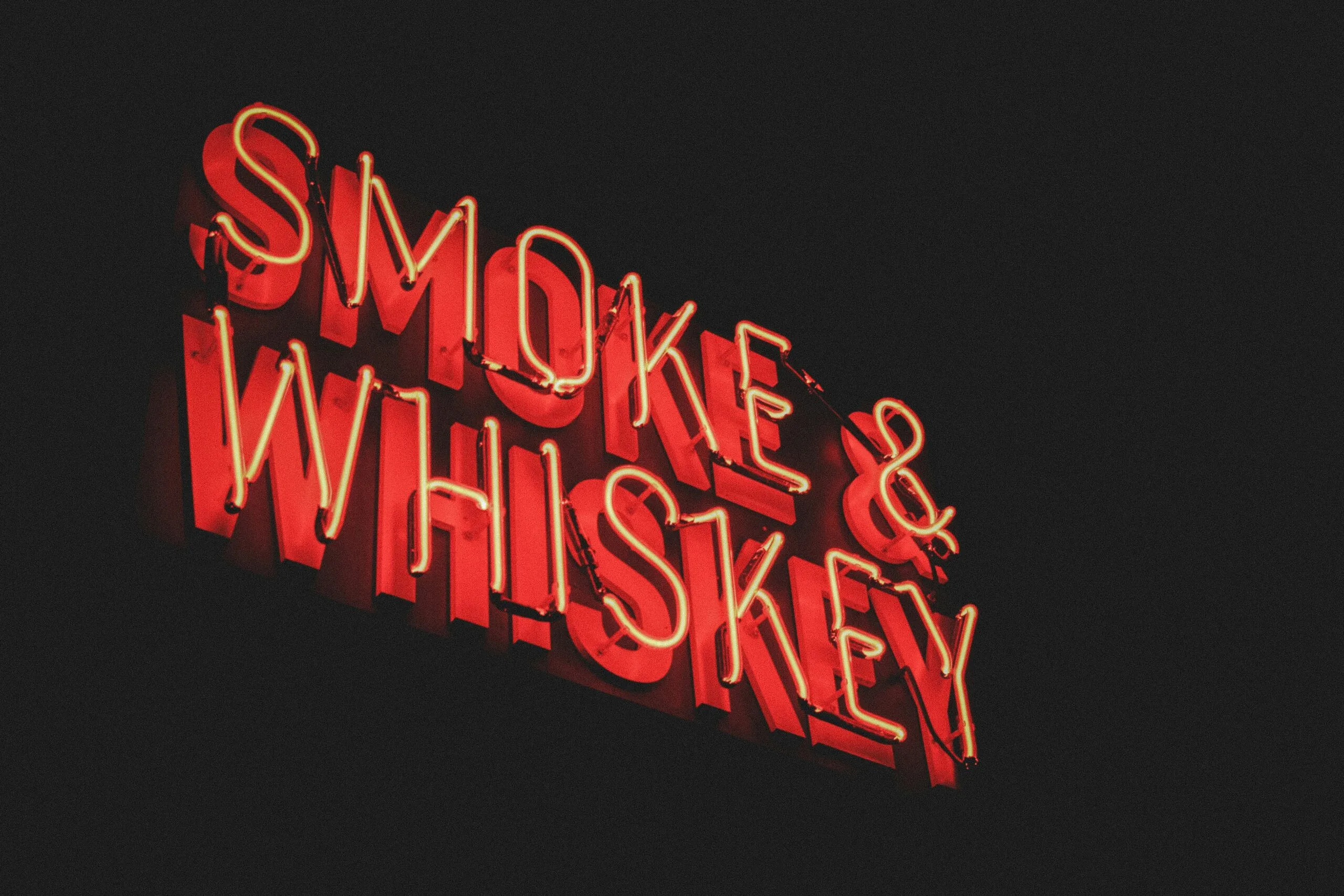 yellow and red Smoke & Whiskey LED signage