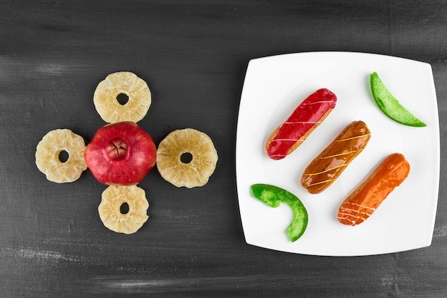 Three variety of eclairs in a white plate.