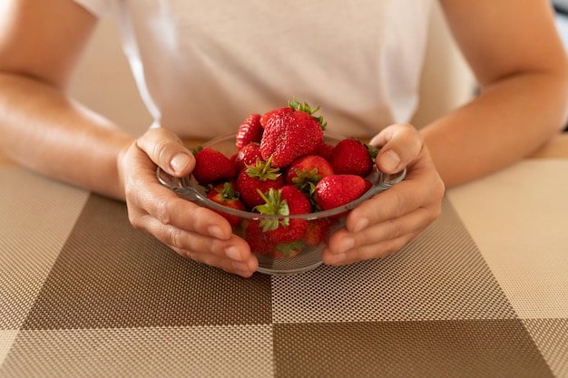 Aromatic strawberries in a womans hands closeup