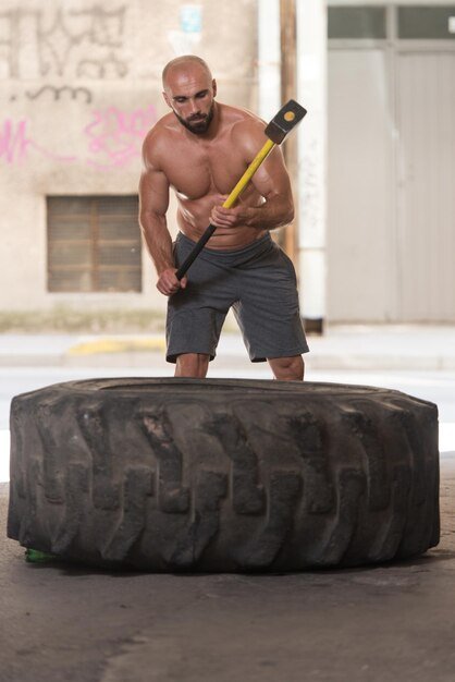Athletic Man Hits Tire In Gym