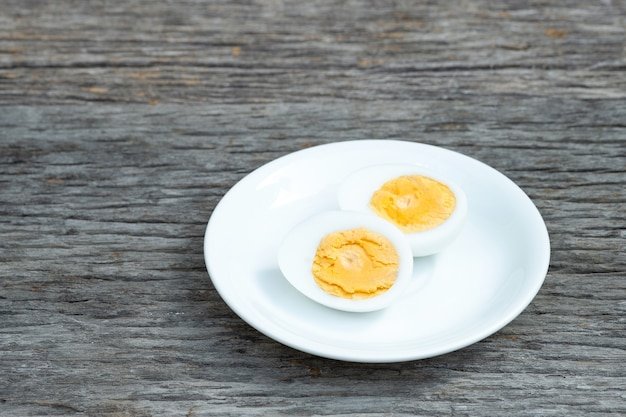 Boiled eggs. Boiled eggs in white ceramic plate on wooden table.