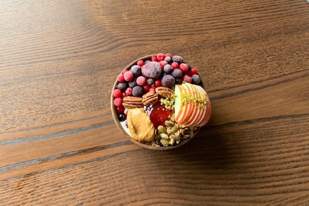 a bowl of fruit with a bunch of raspberries on it