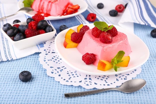Cakes with fruit and berries on plate on lace napkin