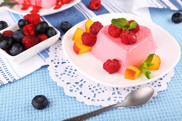 Cakes with fruit and berries on plate on lace napkin