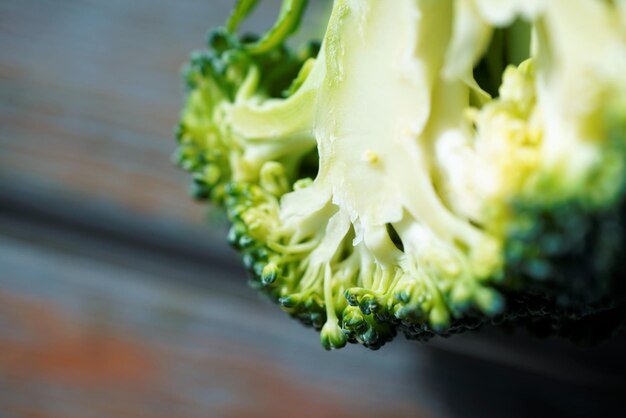 Close-up of green broccoli on wooden surface
