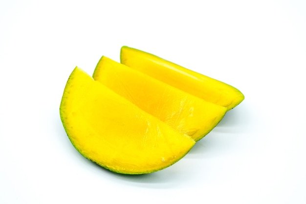 Close-up of yellow slices over white background
