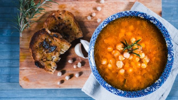 Closeup shot of traditional Italian Chickpea soup with rosemary and bread