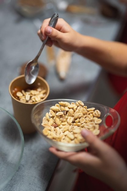 The confectioner sprinkles nuts on the dessert