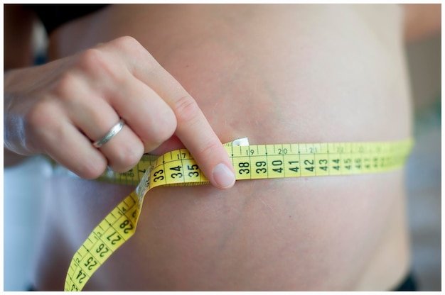 Cropped hand holding tape measure