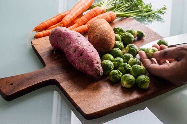 Cropped image of person preparing food on cutting board