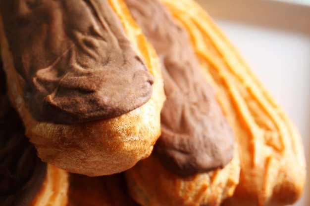 Delicious eclairs with chocolate close up