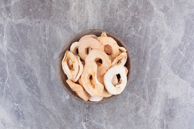 Dried healthy apples on wooden plate. 