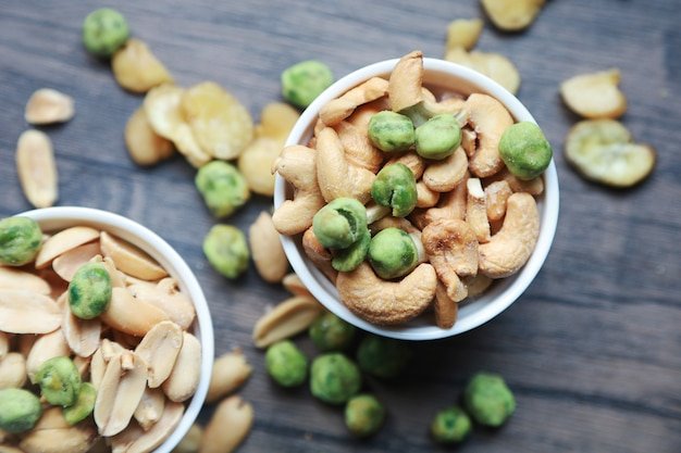 Dried peanuts and cashew on ceramic bowls