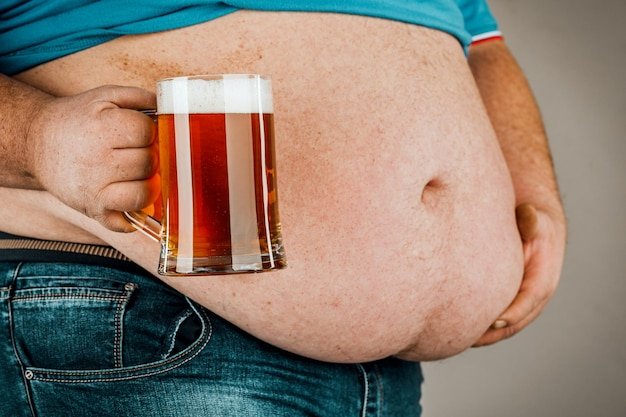 Fat belly due to junk food or beer drink The concept of malnutrition