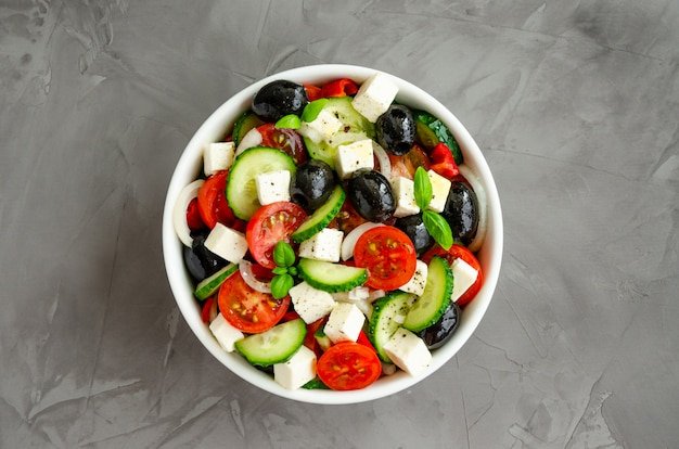 Greek salad of fresh juicy vegetables, feta cheese, herbs and olives