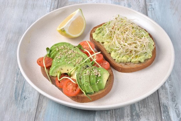 Healthy avocado sandwich , dark bread. Spicy rye toast