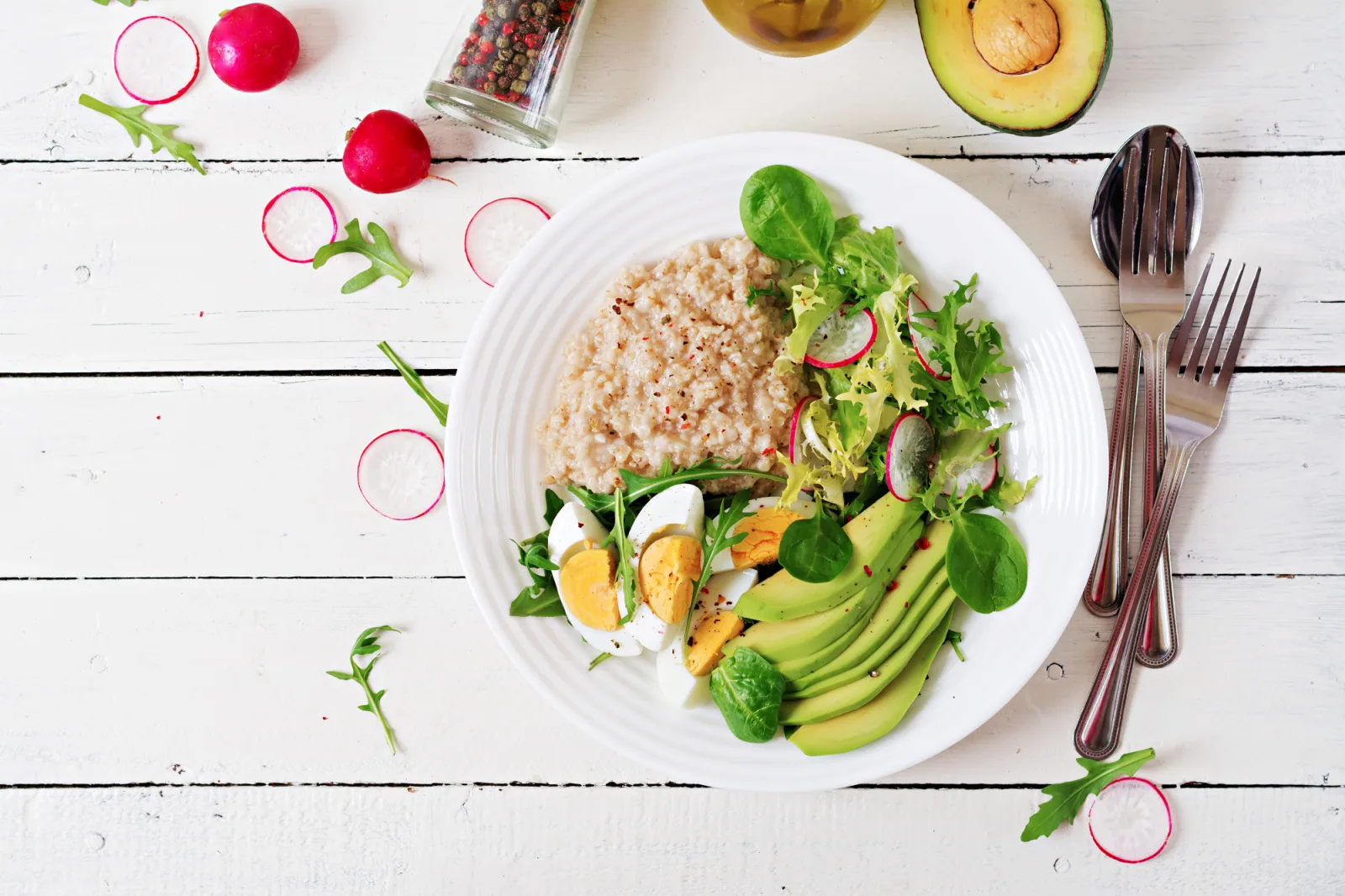 Healthy breakfast. Dietary menu. Oatmeal porridge and avocado salad and eggs. 