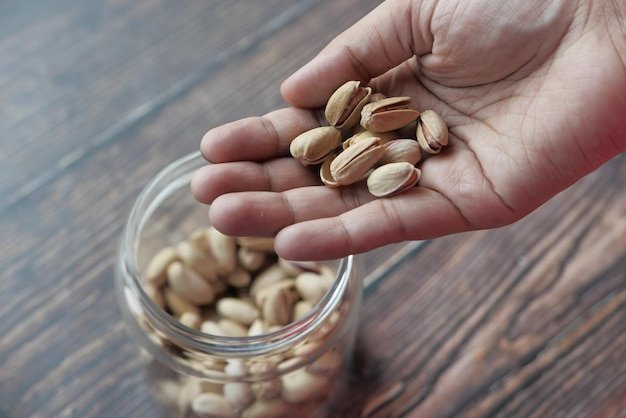 High angle view of pistachios nut on hand