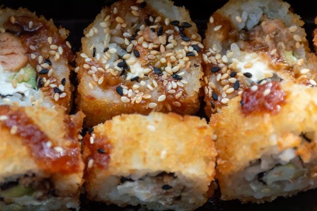 Hot tempura rolls with fish and sesame seeds