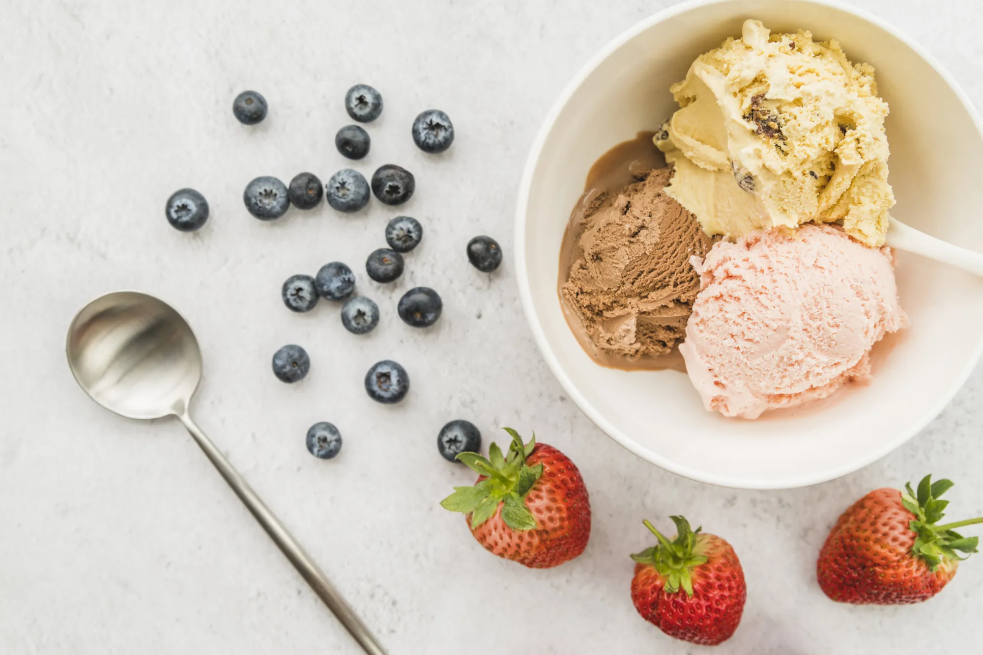 Ice cream in bowl and diverse berries