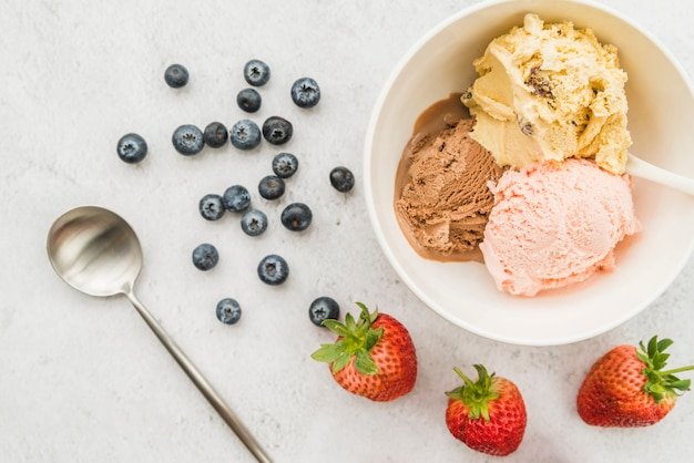 Ice cream in bowl and diverse berries