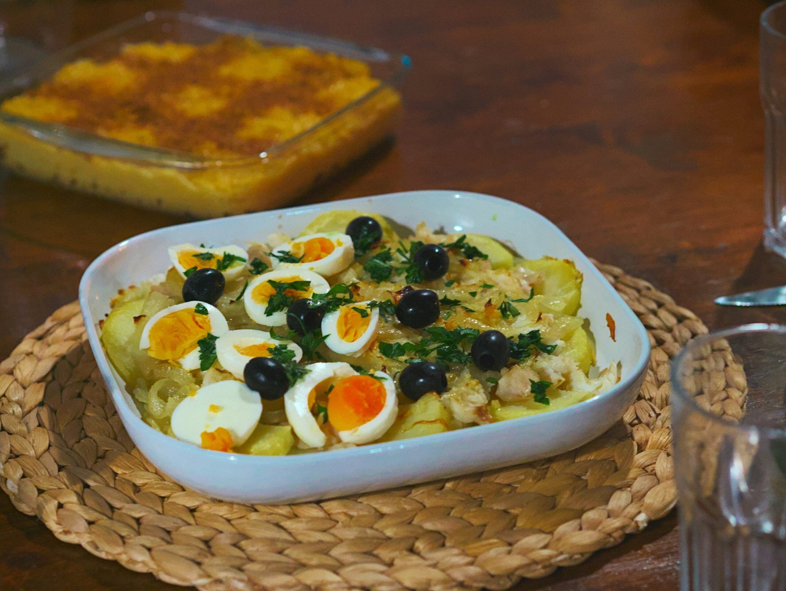 Baked dish with potatoes, eggs, and olives