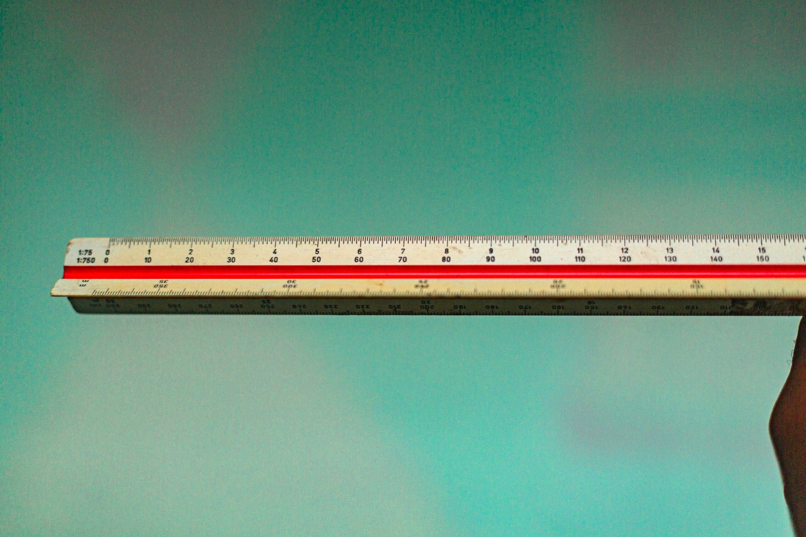a person holding a ruler in their hand