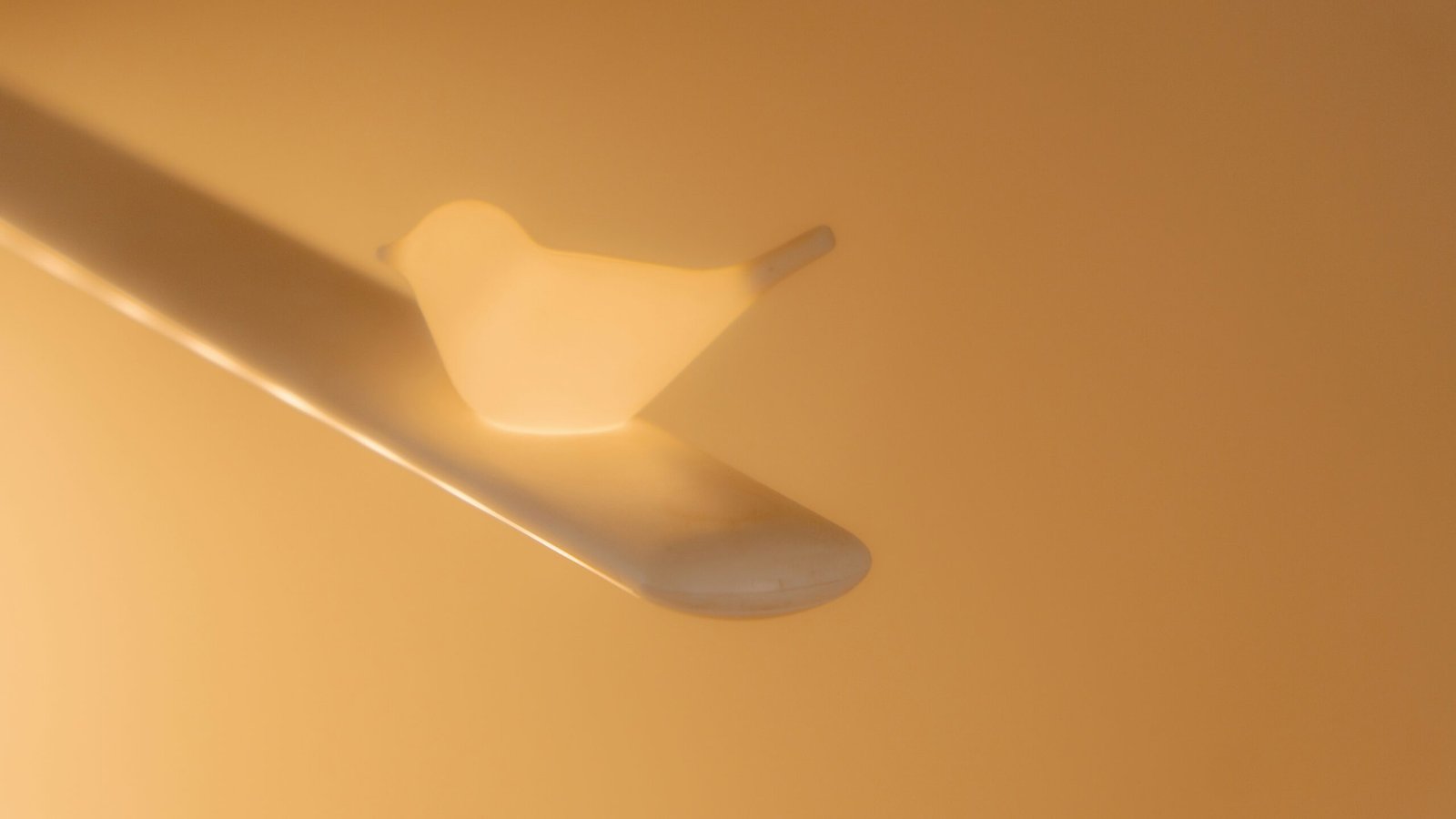 a close up of a white object on a yellow background