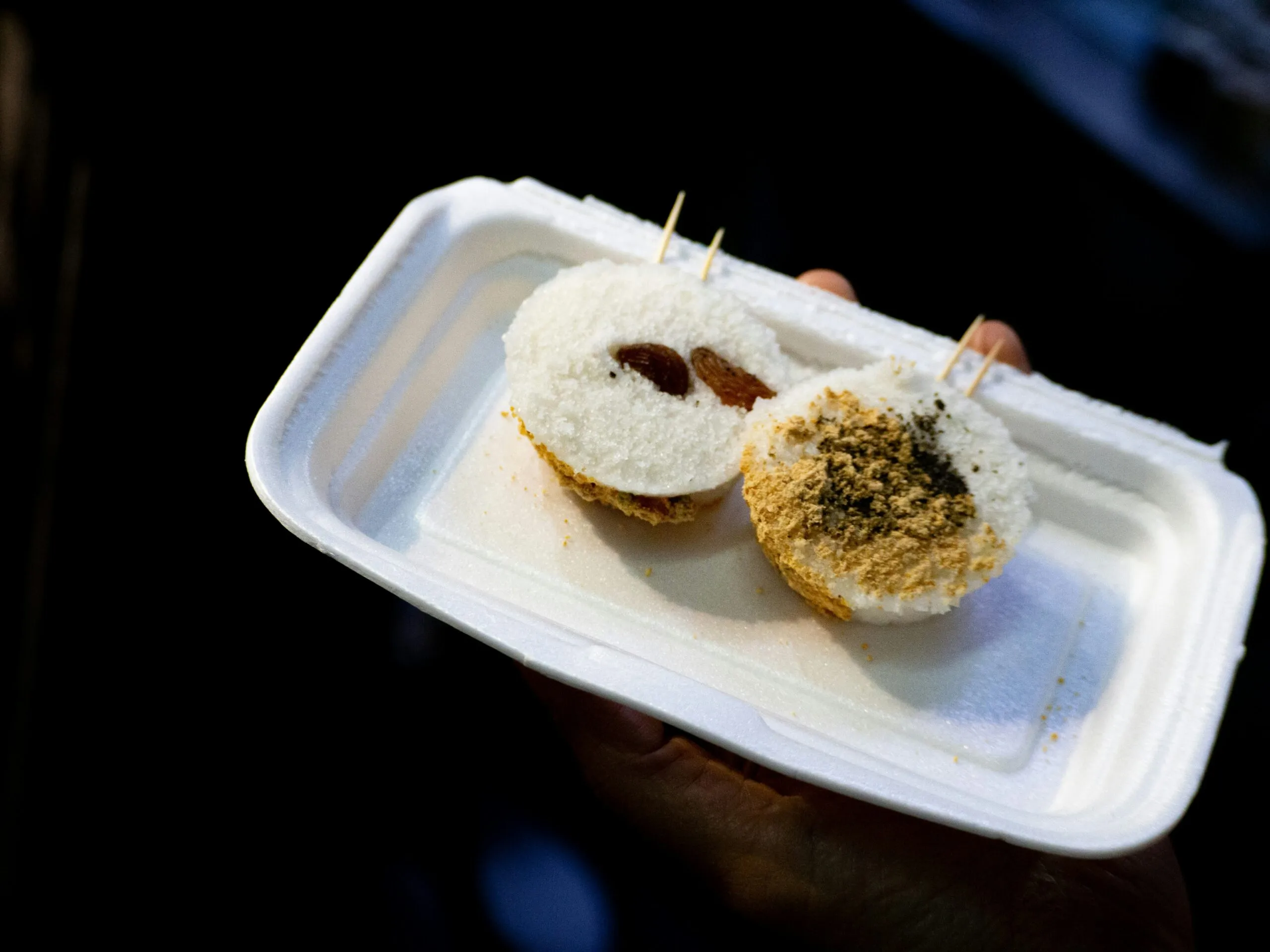 Two small pastries with toppings on a tray