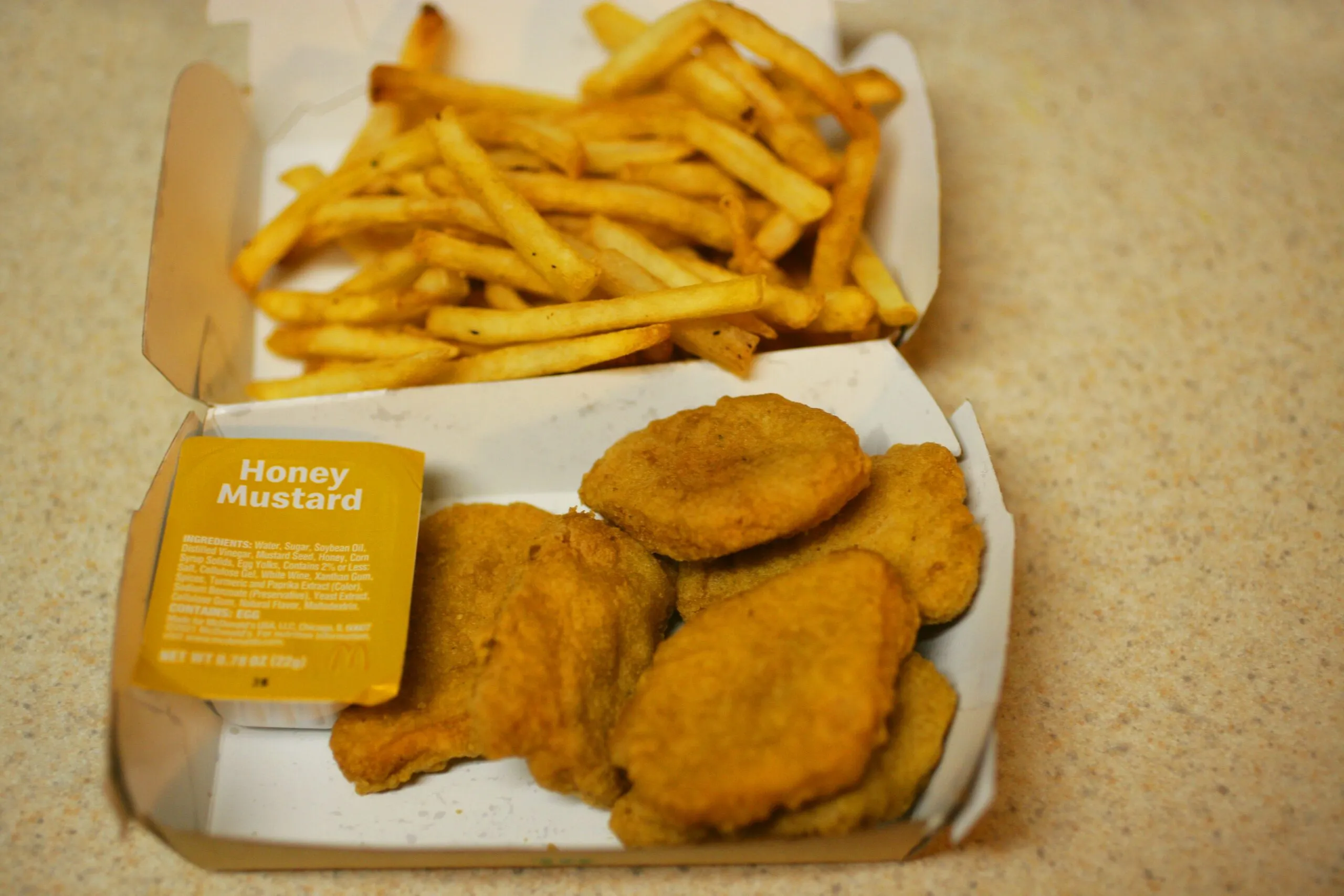 Mcdonald's chicken nuggets and fries are pictured.
