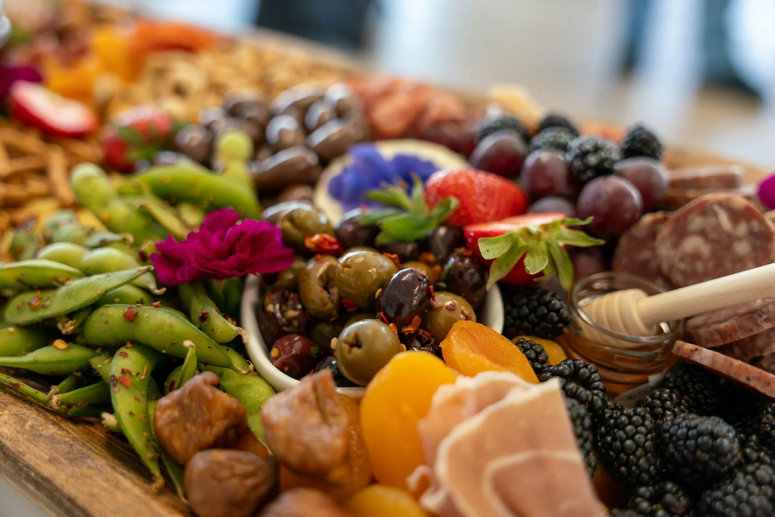 A delicious charcuterie board with fruits and meats.
