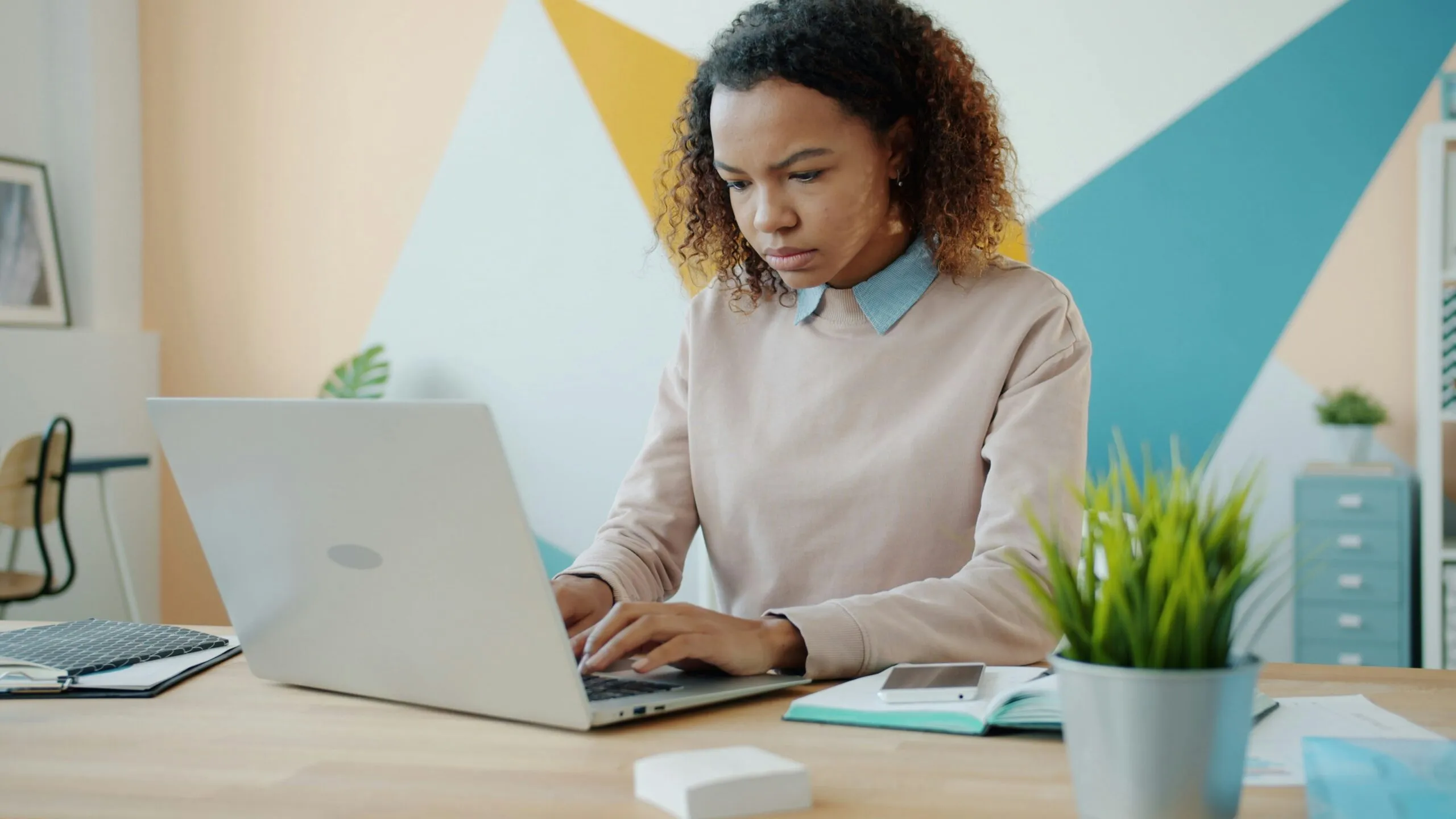 Young woman concentrating while working on a laptop.