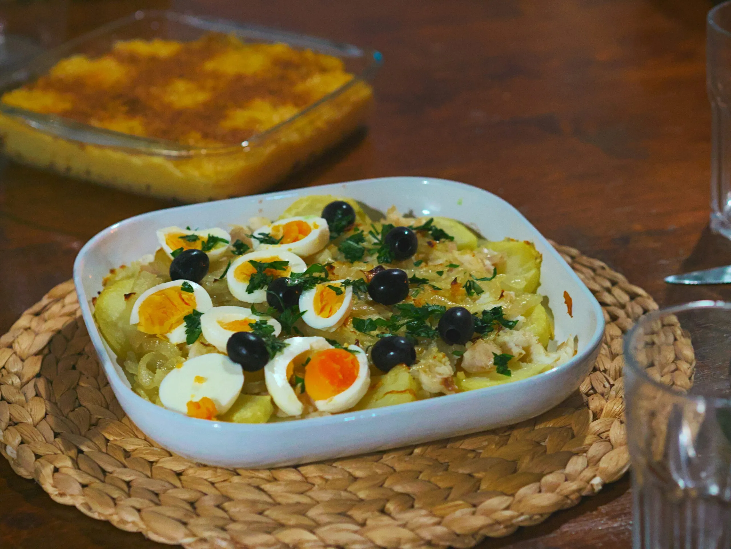Baked dish with potatoes, eggs, and olives