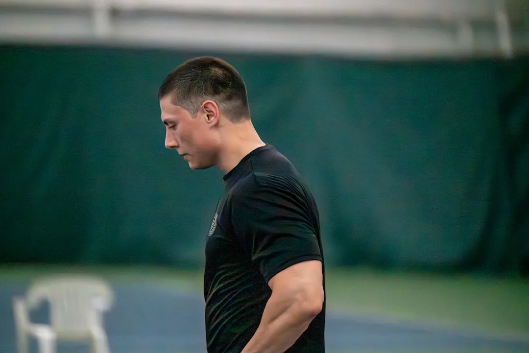 Man in black t-shirt looking down