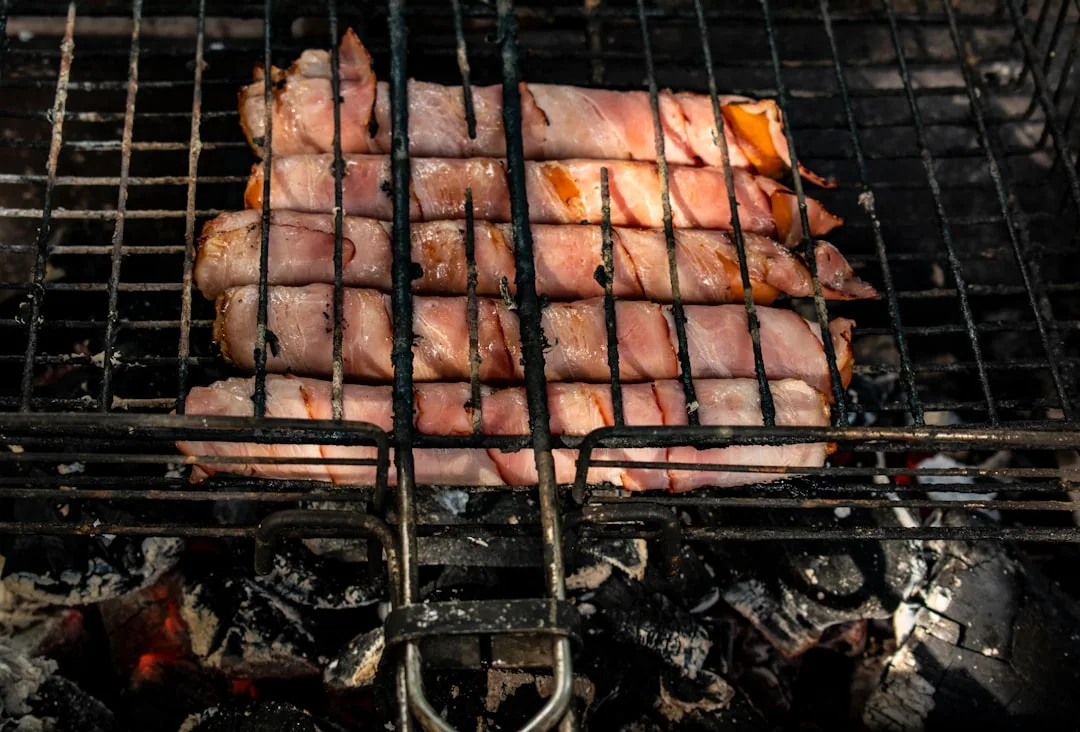 a bunch of meat is cooking on a grill