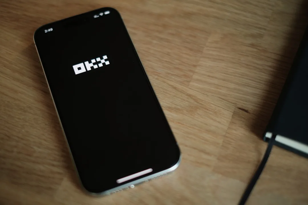 A cell phone sitting on top of a wooden table