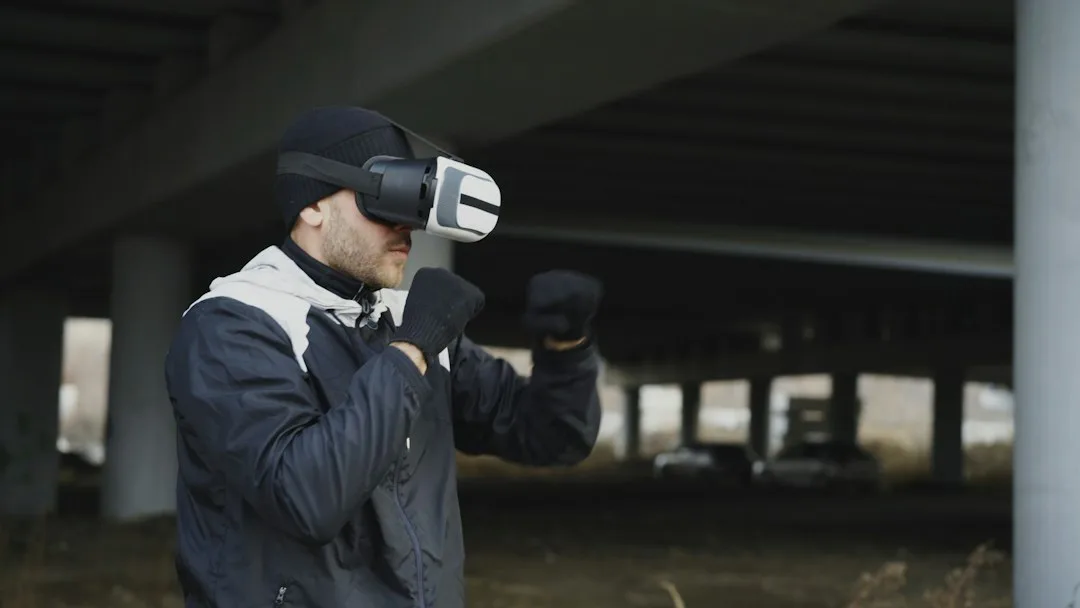 Man wearing vr headset, boxing outdoors under bridge.