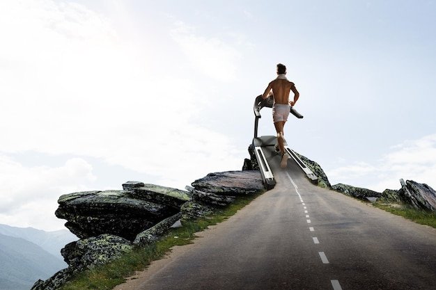 Man running on a treadmill concept for exercising, fitness and healthy lifestyle. Mixed media