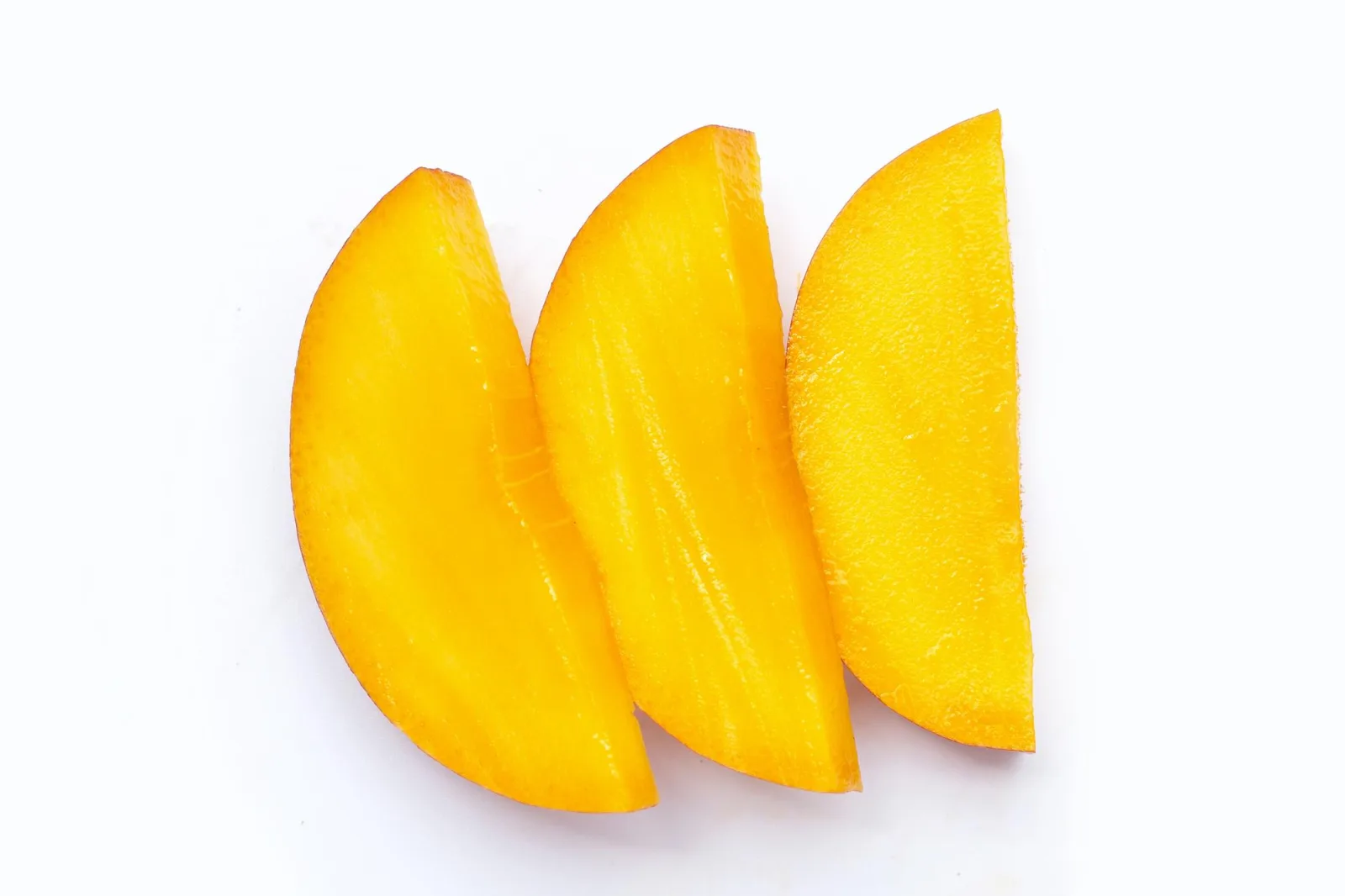Mango fruit slices on white background