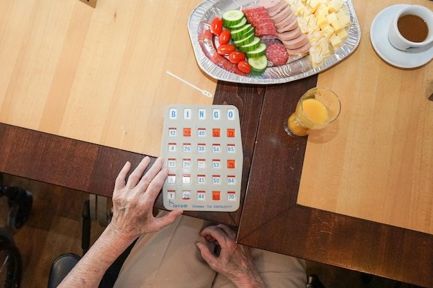 Midsection of man holding ice cream on table at home